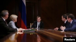 FILE - Russian Prime Minister Dmitry Medvedev (C) chairs a meeting at the Gorki state residence outside Moscow as Russia and China aim to wrap up 10 years of talks about Russian gas supplies