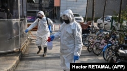Health emergency crew disinfect an area in Wuhan, China during the coronavirus outbreak