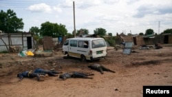 FILE - Slain bodies of civilians killed in renewed attacks lie along a road in Bentiu, Unity state of South Sudan.