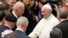 FILE - Pope Francis shakes hands with then U.S. Vice President Joe Biden as they take part in a conference being held at the Vatican, April 29, 2016. 