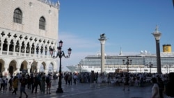 In this file photo, a cruise ship passes by St. Mark's Square in Venice, Italy, Sunday, June 2, 2019. )AP Photo/Luca Bruno)