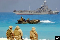 FILE - U.S. marines look out from their amphibious tank during an amphibious assault exercise with Egyptian forces in Bright Star war games, on Egypt's north west coast, Sept. 15, 2005.