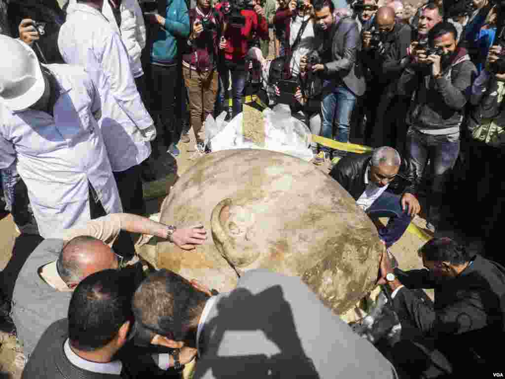Archaeologists examine the condition of the statue and the writings carved on the back. King Ramses II was famous of stealing other kings monuments and carve his name on it.