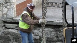 A worker does his job along the San Antonio River Walk in San Antonio, Texas, after the river was drained to clean out silt and make repairs, Jan. 7, 2011