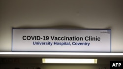 A sign in the Covid-19 Vaccination Clinic at the University Hospital in Coventry, central England is pictured on Dec. 4, 2020, prior to the NHS administering jabs to the most vulnerable early next week.