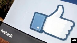 FILE - A Jan. 12, 2012 file photo, shows the Facebook "like" icon displayed outside of Facebook's headquarters in Menlo Park, California. (AP Photo/Paul Sakuma)