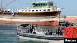 Chinese navy officers dock on the shores of the Gulf of Aden.