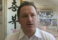 In this image made from video taken on March 2, 2017, Michael Spavor, director of Paektu Cultural Exchange, talks during a Skype interview in Yangi, China.