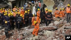 Rescuers work at the site of a building collapse in Mumbai, India, Aug. 31, 2017.