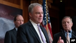 Sen. Tim Kaine, D-Va., center, joined at by Sen. Tom Udall, D-N.M., left, and Sen. Dick Durbin, D-Ill., speak after the Senate approved a bipartisan measure limiting President Trump's authority to launch military operations against Iran, Feb. 13, 2020.