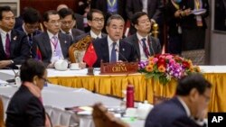 China's Foreign Minister Wang Yi, center back, attends the Special ASEAN-China Foreign Ministers' meeting on the Novel Coronavirus Pneumonia in Vientiane, Laos, Feb. 20, 2020.