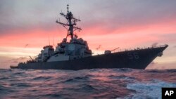 In this Jan. 22, 2017, photo provided by U.S. Navy, the USS John S. McCain conducts a patrol in the South China Sea while supporting security efforts in the region. 