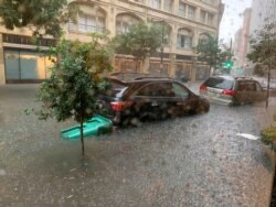 Vehicles sit in high waters after heavy rain in New Orleans, Louisiana, July 10, 2019, in this image obtained from social media.