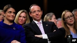 FILE - Deputy Attorney General Rod Rosenstein, center, listens to lawmakers speak during a during a Senate Judiciary Committee's nominations hearing on Supreme Court nominee Brett Kavanaugh, on Capitol Hill in Washington, Sept. 4, 2018.