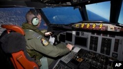 Captain Flt. Lt. Tim McAlevey of the Royal New Zealand Air Force flies a P-3 Orion in search for the missing Malaysia Airlines Flight 370 over the Indian Ocean, April 11, 2014.