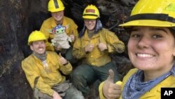 Lucas Galloway, from left, Jaebyn Drake, Rhett Schieder and Audrey Wilcox pose for a selfie with Baby Yoda on Sept. 20, 2020, while fighting the Holiday Farm Fire in Blue River, Oregon. 