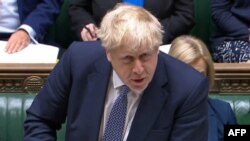 Potongan gambar dari video parlemen Inggris yang menunjukkan Perdana Menteri Boris Johnson tengah menjawab pertanyaan-pertanyaan yang diajukan oleh para anggota parlemen di Dewan Perwakilan Parlemen, di London, pada 12 Januari 2022. (Foto: via AFP)