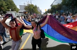 Participants dance during a gay pride march in Belgrade, Serbia, Sept. 17, 2017.