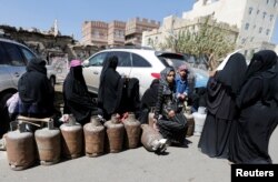 Women wait to fill up cooking gas cylinders outside a gas station amid supply shortage in Sanaa, Yemen, Nov. 7, 2017.