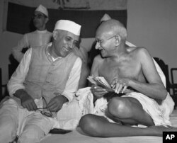 Mahatma Gandhi, who eventually led India to its independence, laughs with the man who was to be the nation's first prime minister, Jawaharlal Nehru, at the All-India Congress committee meeting in Bombay, India, on July 6, 1946.