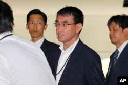 Japan's new Foreign Minister Taro Kono, center, leaves the prime minister's official residence in Tokyo, Aug. 3, 2017.