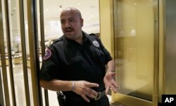 FILE - Security guard Eric Leon discusses automation while on duty at Westfield Valley Fair shopping center in San Jose, California, June 26, 2017.