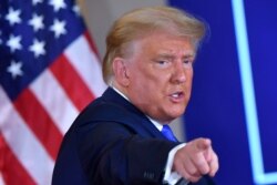US President Donald Trump gestures after speaking during election night in the East Room of the White House in Washington on Nov. 3, 2020.