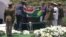 In this video frame grab, military officers remove a South African flag from Nelson Mandela's casket at his burial site in Qunu, South Africa, Sunday, Dec. 15, 2013.