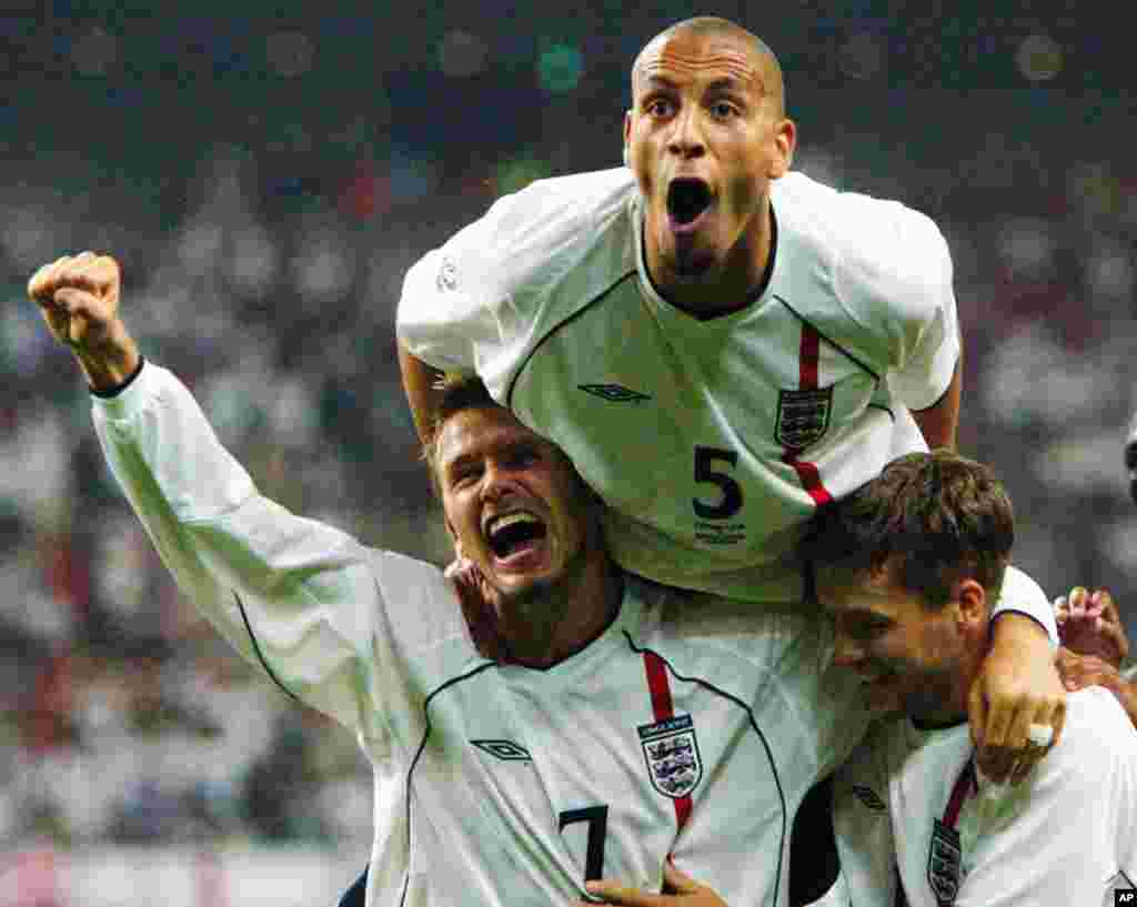 David Beckham, Rio Ferdinand (atas) dan Michael Owen (kanan) merayakan gol kedua tim Inggris yang dicetak Owen pada babak kedua Piala Dunia 2002 melawan Denmark di Nigata, Jepang. (AP/David Guttenfelder)