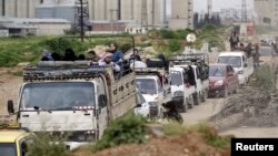 Residents fearing airstrikes by the forces of Syria's President Bashar Al-Assad, flee the city of Idlib, after rebel fighters took control of the area, March 28, 2015. 