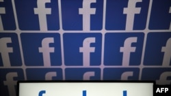FILE - A photo taken July 4, 2019, in Nantes, France, shows logos of the U.S.-based social media platform Facebook. 