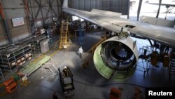 FILE - Workers convert a passenger plane into a cargo plane at Israel Aerospace Industries site in Ben Gurion International Airport, in Lod, Israel December 10, 2020. (REUTERS/Ronen Zvulun)