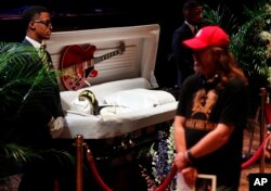 Fans pay their respects to the rock 'n' roll legend Chuck Berry during a public viewing, April 9, 2017, in St. Louis.