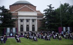 Undergraduate students and university staff wearing face masks attend a graduation ceremony in Tsinghua University, following the outbreak of the coronavirus disease, in Beijing, China, June 23, 2020.