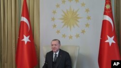 Turkey's President Recep Tayyip Erdogan participates in a video conference with European Commission President Ursula von der Leyen and European Council President Charles Michel, from an old Ottoman palace in Istanbul, March 19, 2021.