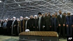 In this picture released by an official website of the office of the Iranian supreme leader, Supreme Leader Ayatollah Ali Khamenei, foreground center, leads a prayer over the casket of former President Akbar Hashemi Rafsanjani at the Tehran University cam