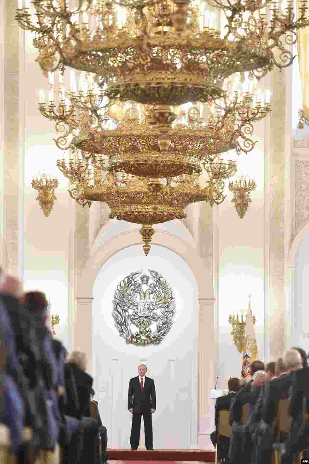 Russian President Vladimir Putin stands during the State Prize awards ceremony marking the &#39;Day of Russia&#39; at the Grand Kremlin Palace in Moscow.