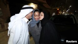 Hannan Iskandar is kissed by her parents, after she drove her car in her neighborhood, in Al Khobar, Saudi Arabia, June 24, 2018.