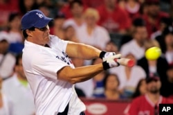 FILE - Former major leaguer Jose Canseco hits during a home run derby against former Los Angeles Angels player Tim Salmon, in Anaheim, Calif., July 3, 2011.