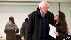 Democratic presidential candidate Sen. Bernie Sanders is hugged by a voter after voting in the Vermont primary in Burlington, Vermont, Tuesday, March 1, 2016, on Super Tuesday. (AP Photo/Jacquelyn Martin)
