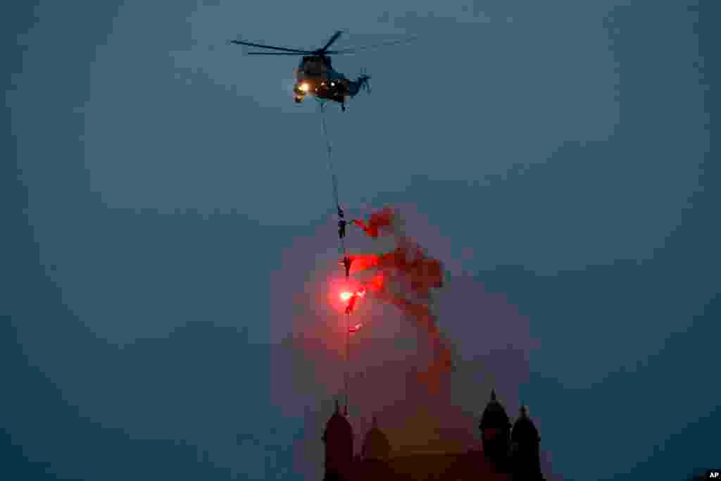 Indian navy personnel display their skills during Naval Day celebrations near the Gateway of India monument in Mumbai.