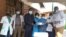 Members of the COVID Response Private Citizens Initiative donate medical equipment at a public hospital in Malawi. (COVID Response Private Citizens Initiative)