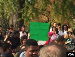 At protests in front of the U.S. Supreme Court a Washington D.C. high school student holds a sign reading “Please do not cut my education funding!” (E. Sarai/VOA)