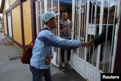 Honduran migrant Ariel, 19, who is waiting for his court hearing for asylum-seekers, leaves a shelter in Tijuana, Mexico, March 19, 2019.