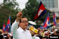 FILE - Sam Rainsy (C), leader of the opposition Cambodia National Rescue Party is seen speaking at a protest in central Phnom Penh.