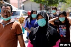A family tries to find their house after an earthquake hit Petobo neighborhood in Palu, Indonesia, Oct. 5, 2018.