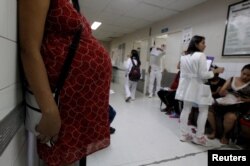 FILE - Pregnant woman waits for a routine general checkup, which includes Zika screening, at the maternity ward of the Hospital Escuela in Tegucigalpa, Honduras, Jan. 27, 2016.