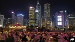 FILE - People watch a movie in an outdoor park in Hong Kong, November 10, 2020. 