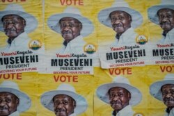 Posters of Uganda's President Yoweri Museveni who is running for his 6th presidential term are seen on a wall in Kampala, Uganda, on Jan. 4, 2021.