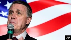 FILE - In this Nov. 13, 2020, photo, Sen. David Perdue speaks during a campaign rally, in Cumming, Ga.